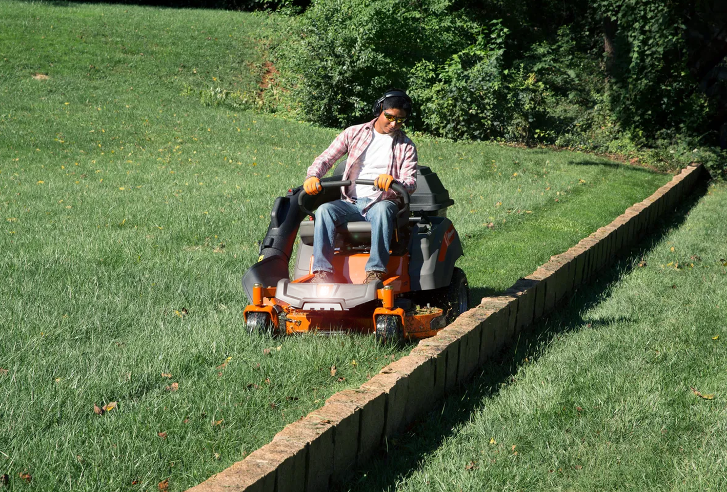 Man examining new electric lawn mowers.