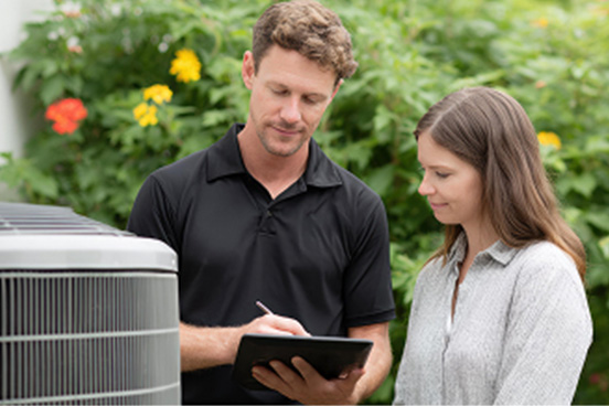 HVAC professional with tablet accessing Synchrony business tools.